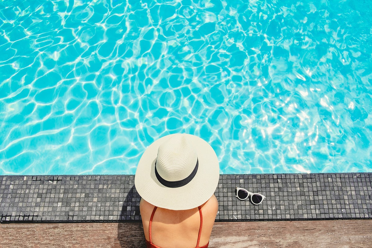 lady relaxing by a pool