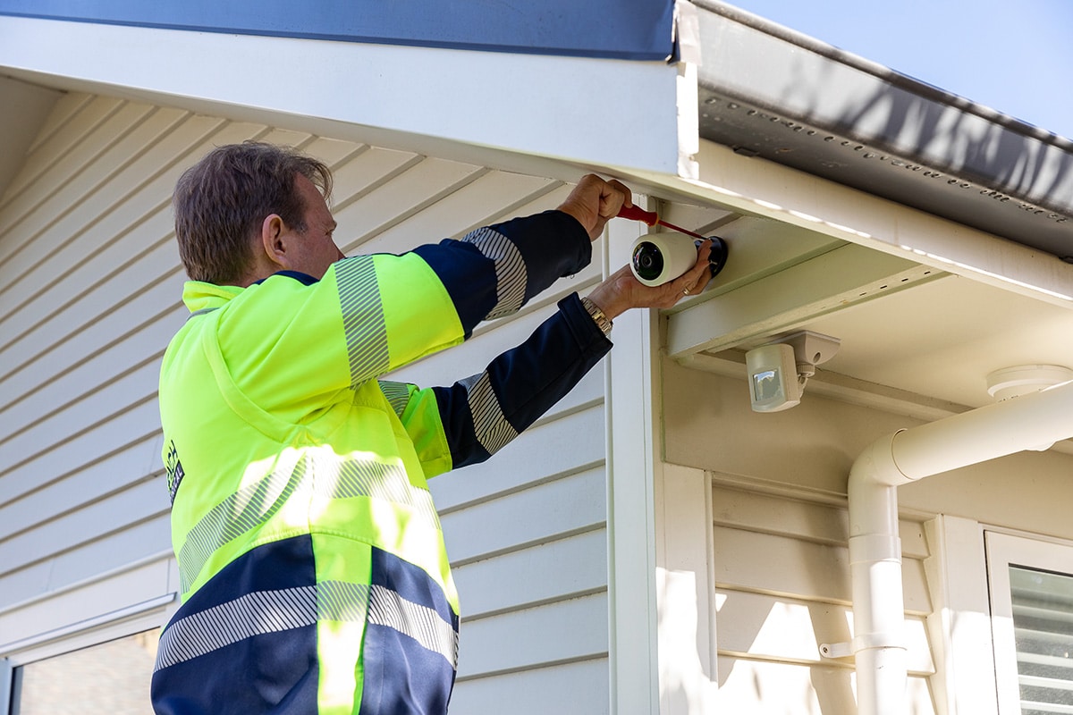 electrician installing home security camera