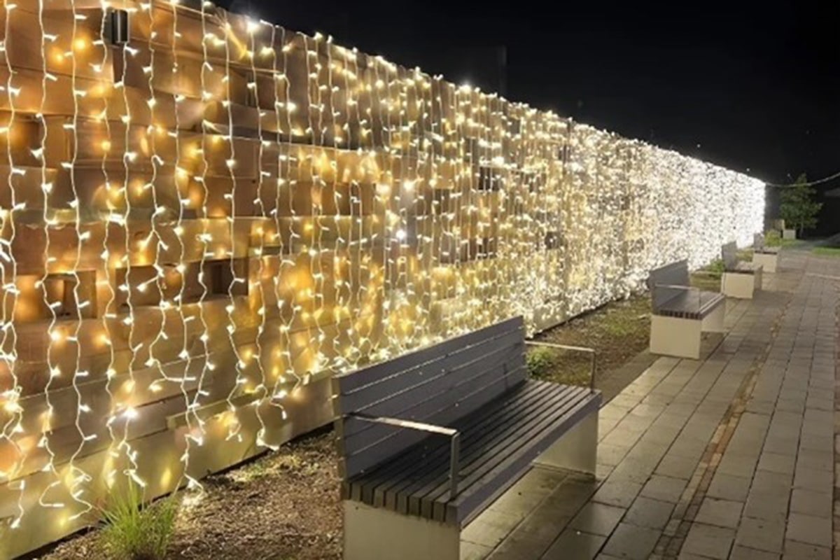 fairy lights hanging on park wall